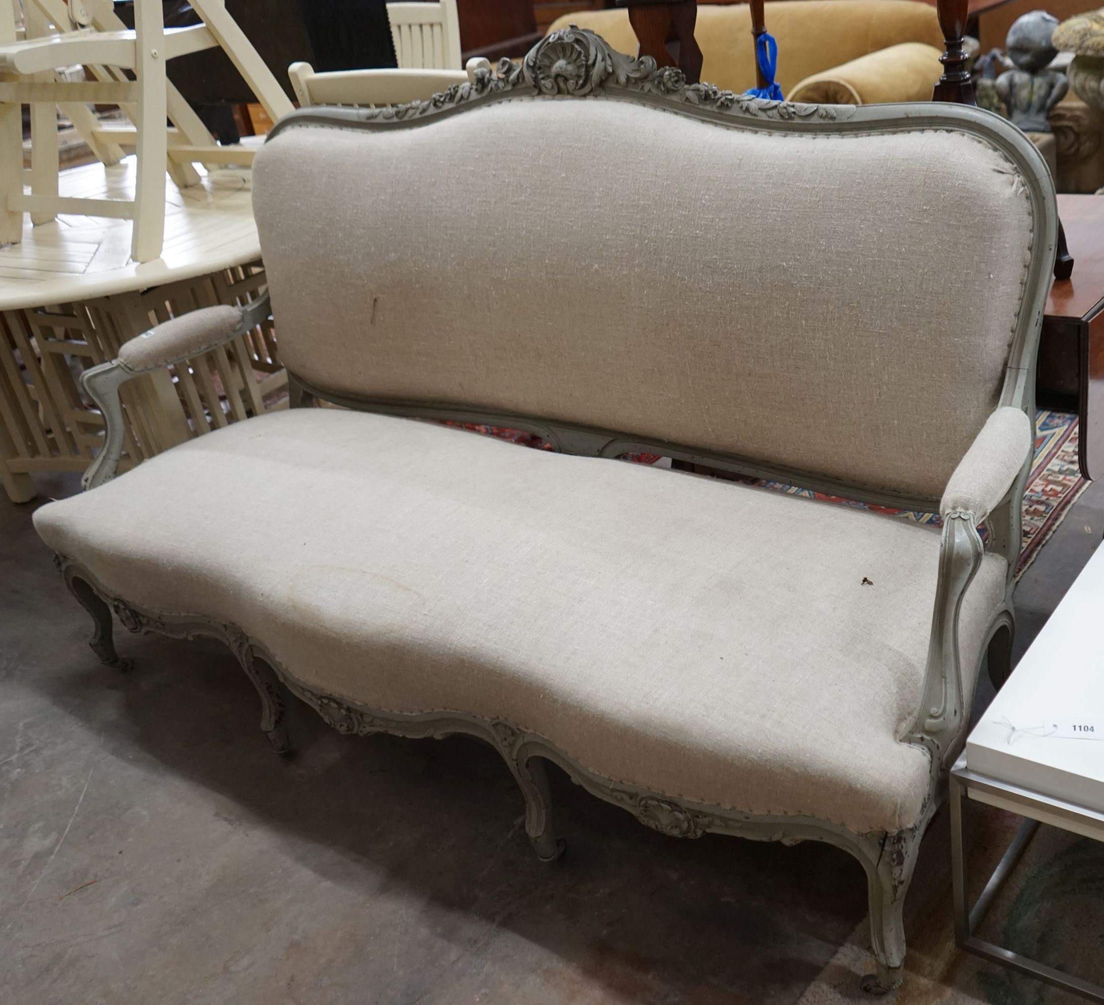 A 19th century French carved wood settee upholstered in a natural linen type fabric, re-painted in grey, length 180cm, depth 60cm, height 102cm
